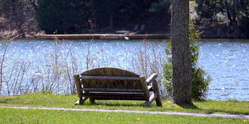 muskoka chair on dock overlooking lake