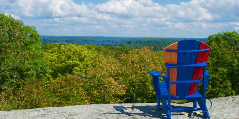 muskoka chair at top of rock lookout